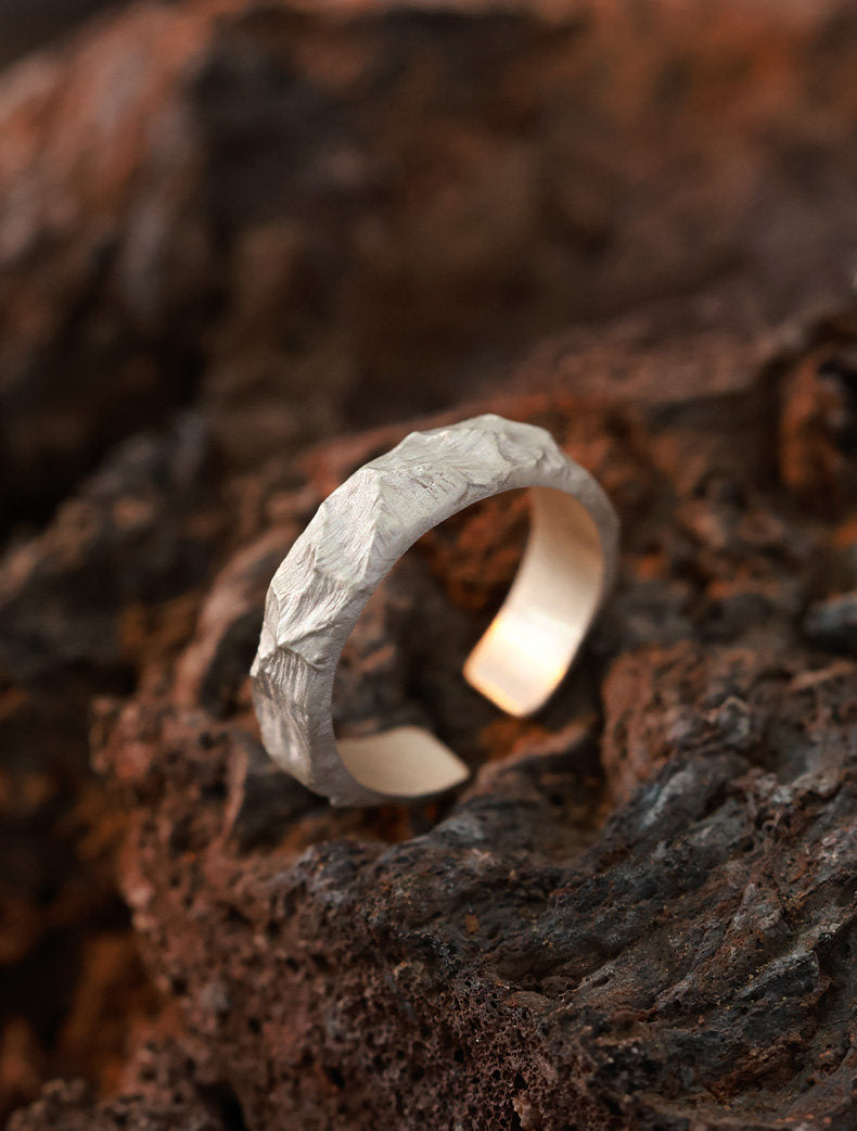 Kailash Ridge Band — hand-chiseled 999 silver open-band ring on volcanic stone