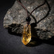 Raw amber citrine crystal pendant necklace on dark basalt stone — Dorje Studio