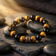 Obsidian & Tiger Eye Bracelet - hero on river stone
