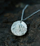 Kailash Peak Relic Pendant — fine silver 999 hand-carved mountain round pendant on stone